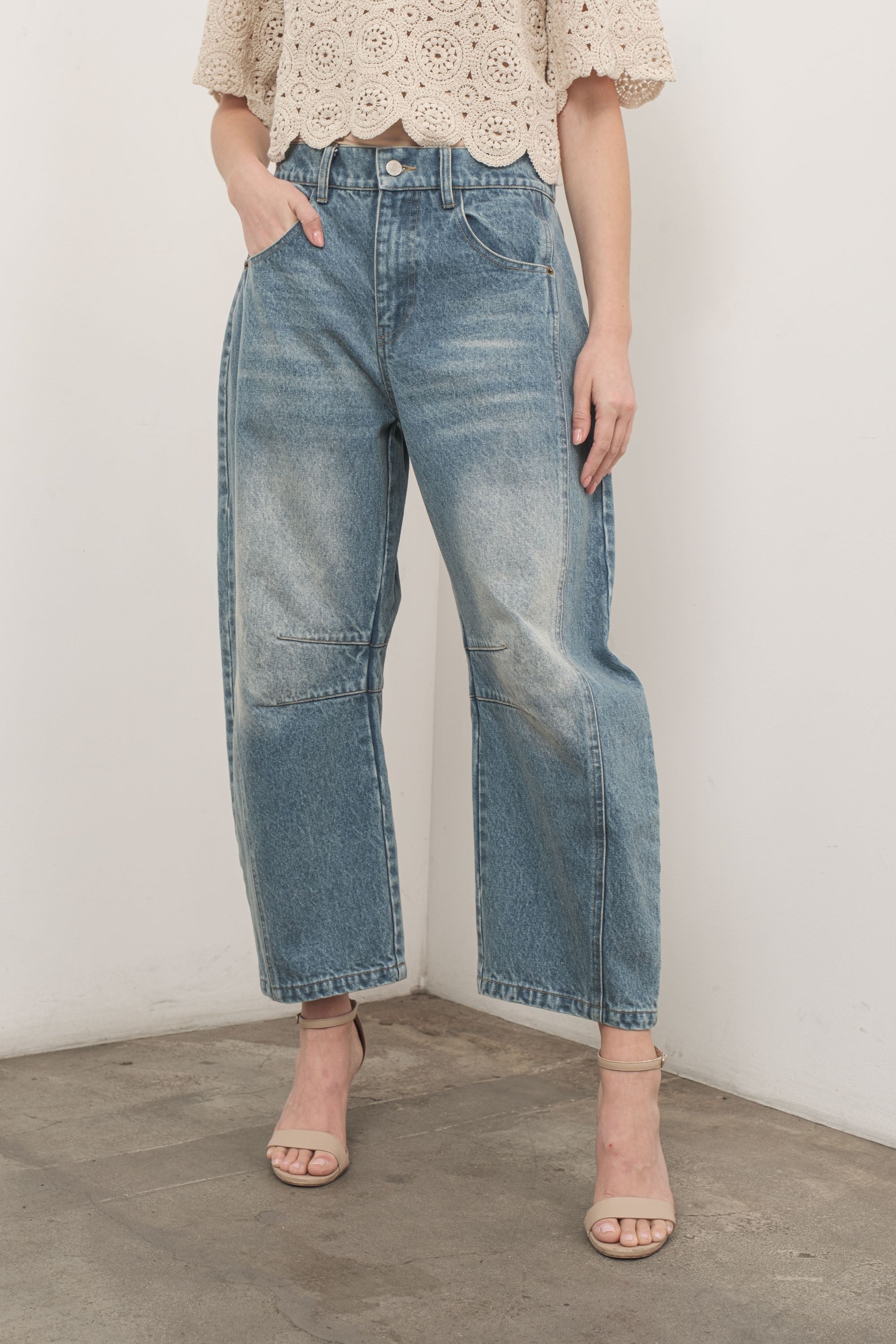 Model is wearing Good Luck Barrel Jeans in Washed Denim - front view - relaxed pose