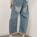 Model is wearing Good Luck Barrel Jeans in Washed Denim - back view