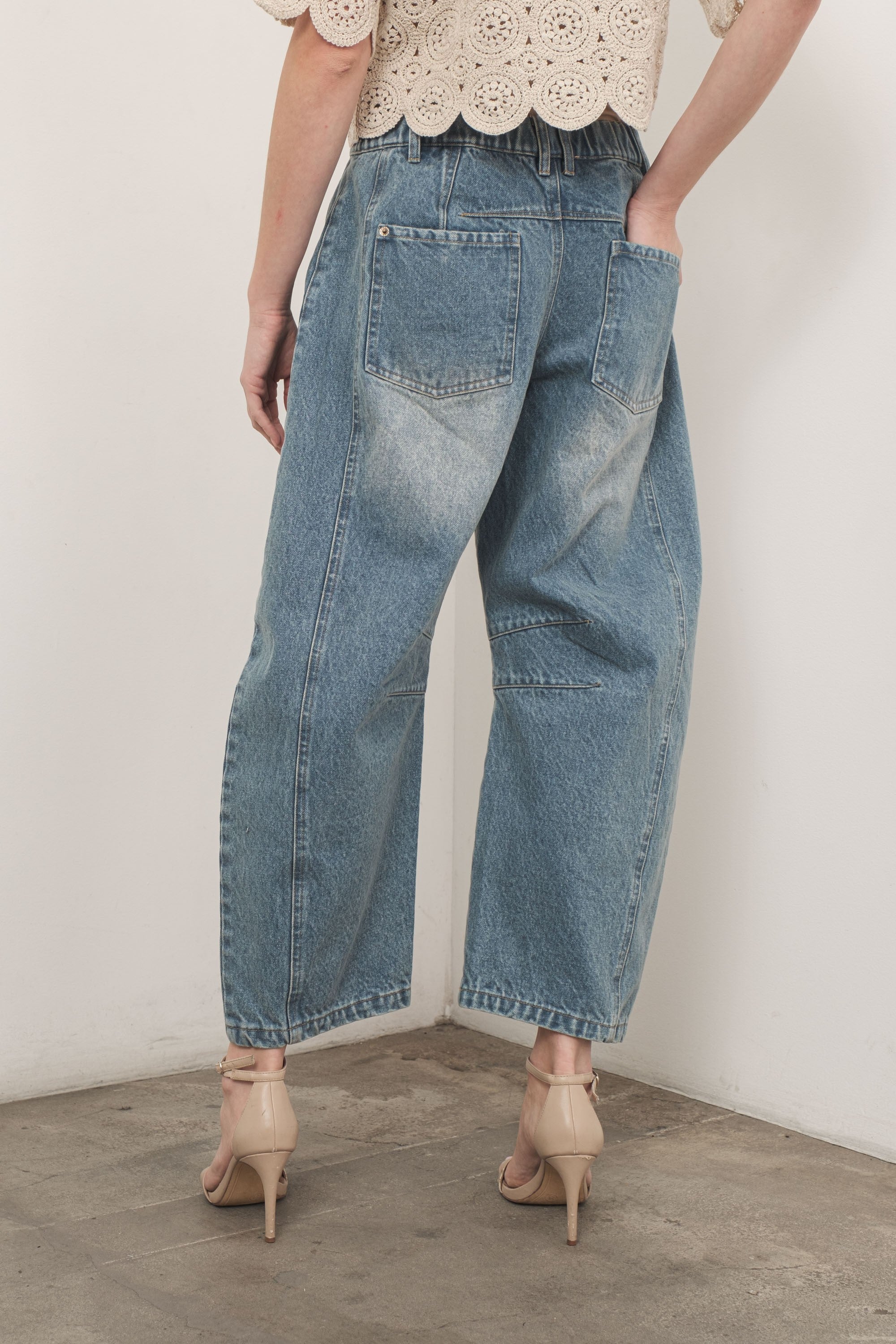 Model is wearing Good Luck Barrel Jeans in Washed Denim - back view
