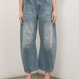 Model is wearing Good Luck Barrel Jeans in Washed Denim - front view