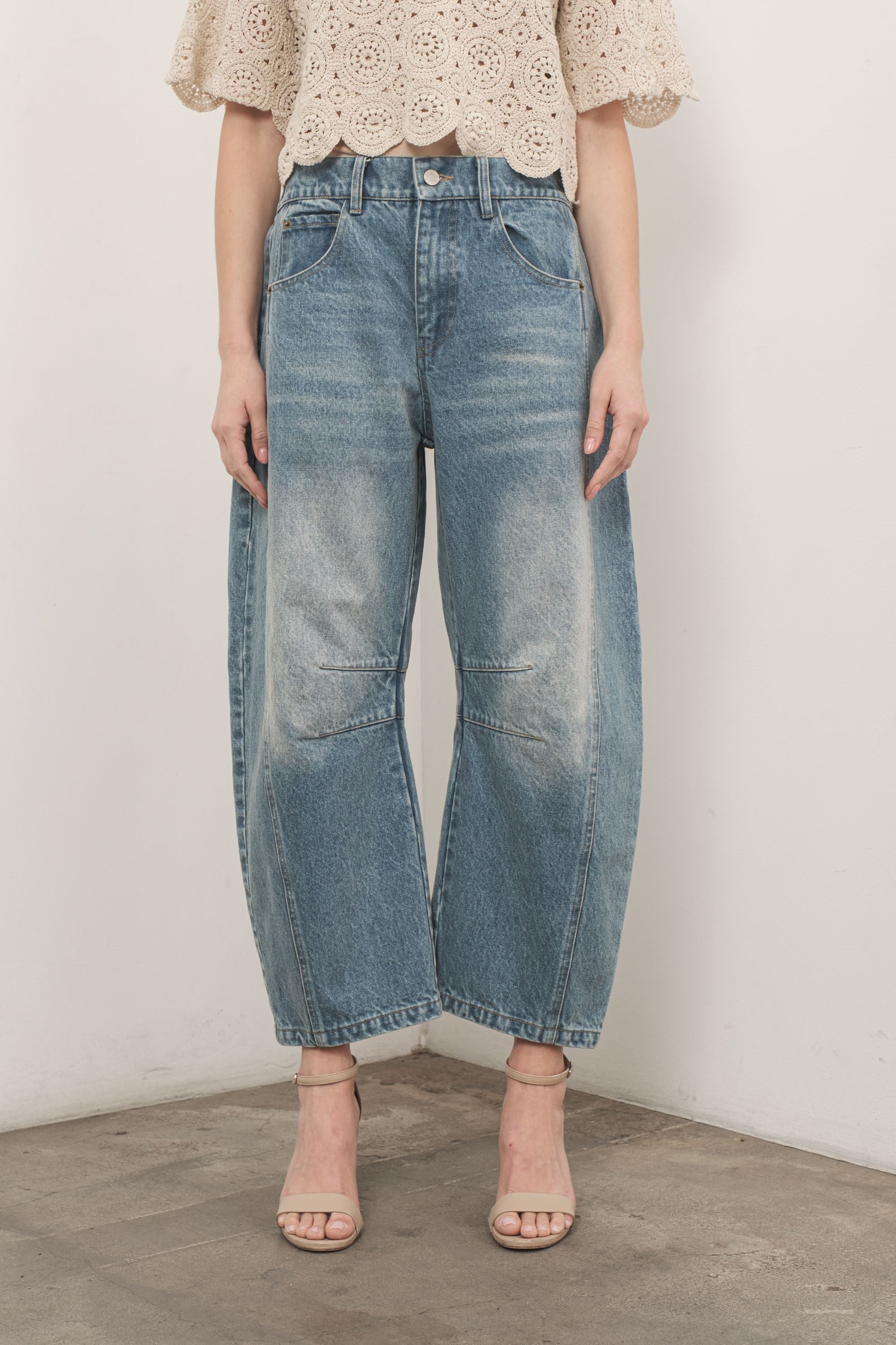 Model is wearing Good Luck Barrel Jeans in Washed Denim - front view