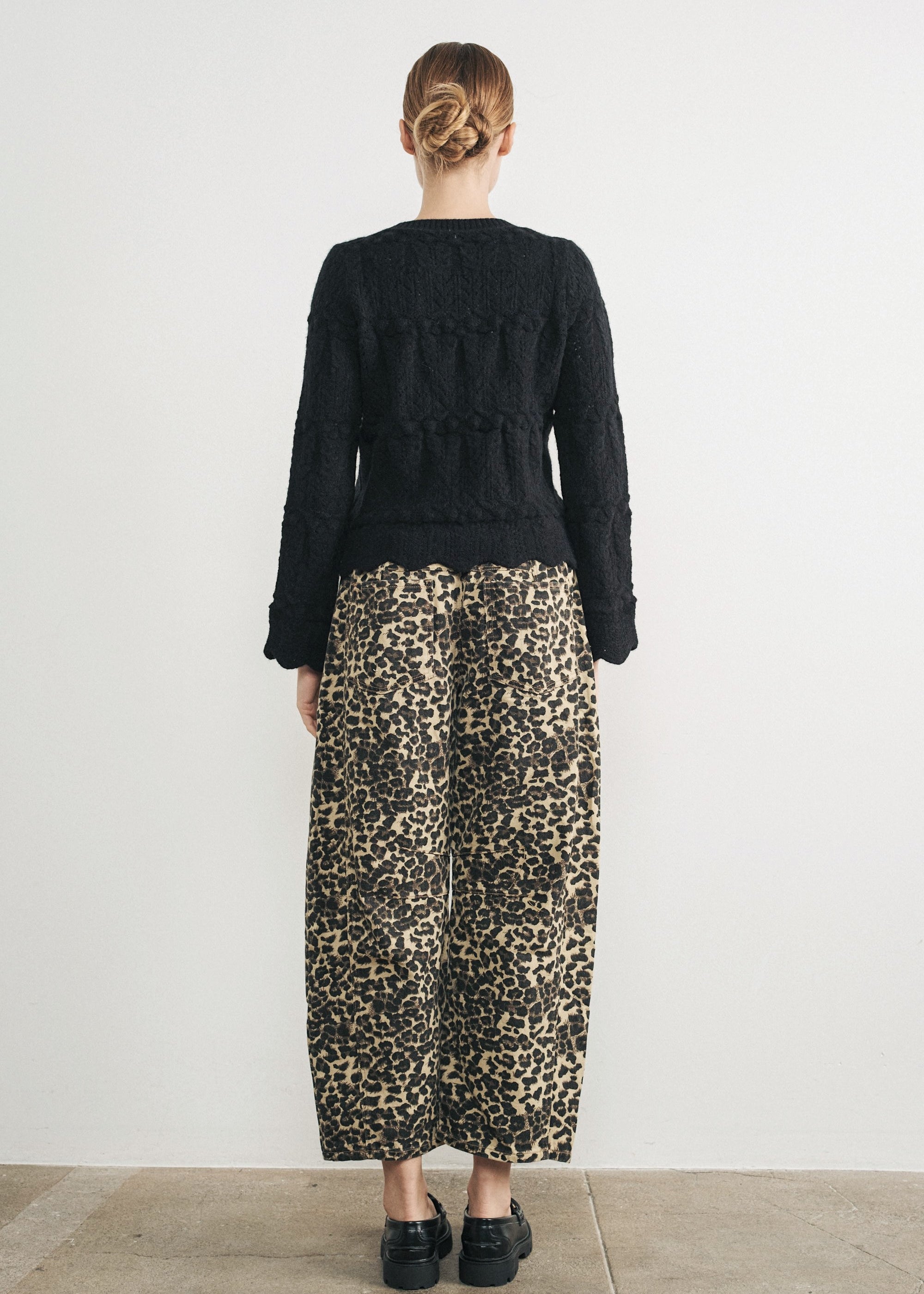 Woman wearing Good Luck Barrel Jeans in Leopard and black sweater - back view