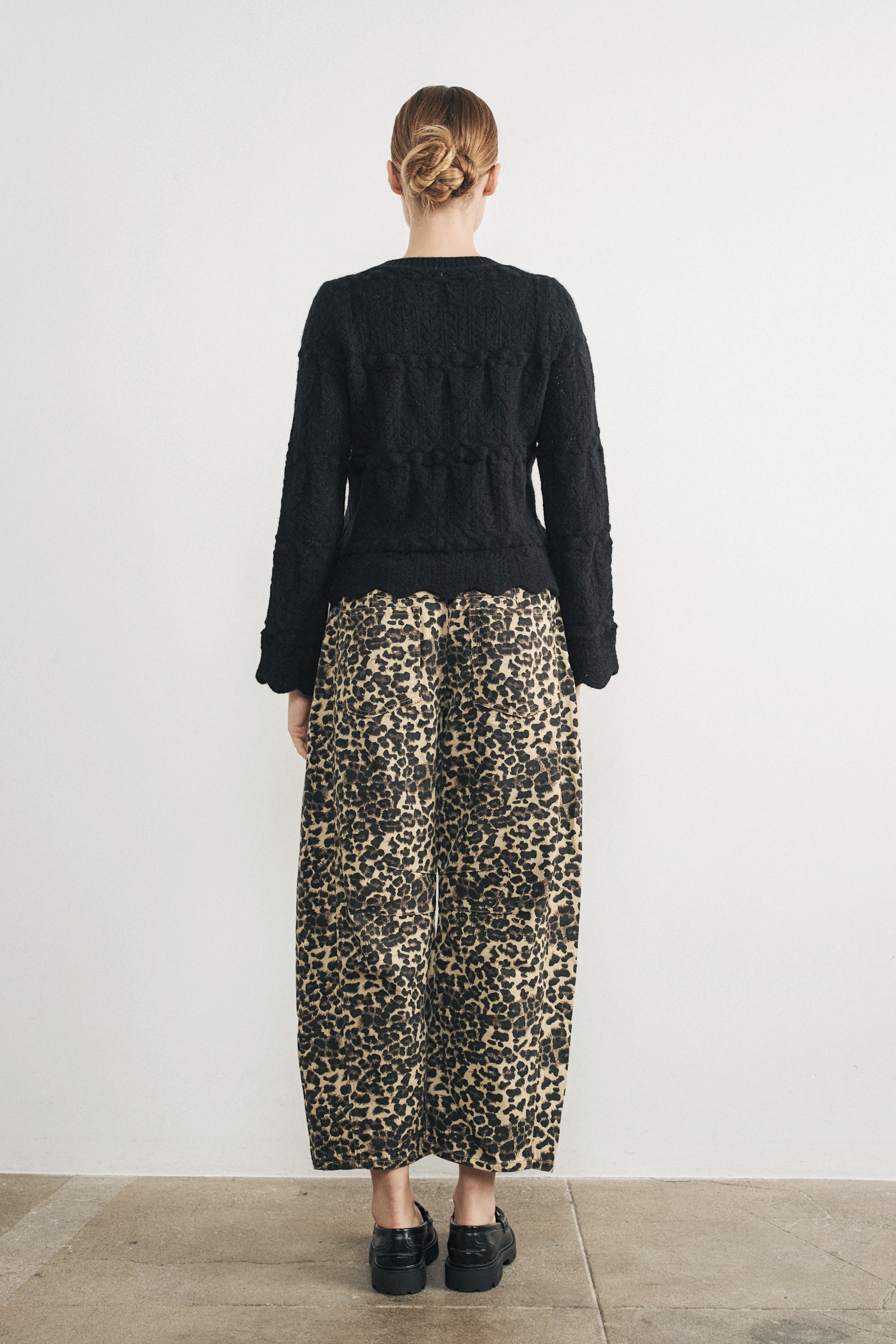 Woman wearing Good Luck Barrel Jeans in Leopard and black sweater - back view
