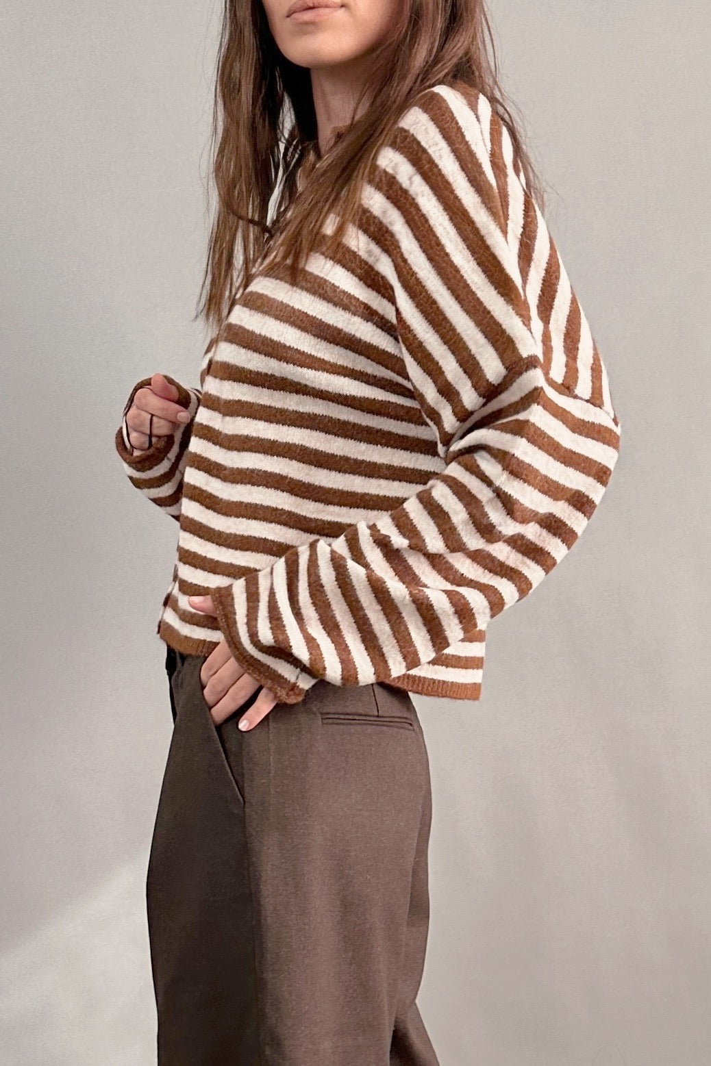 Side view of Hailey Button Down Cardigan in Ivory Brown Stripe paired with brown shorts, relaxed everyday outfit