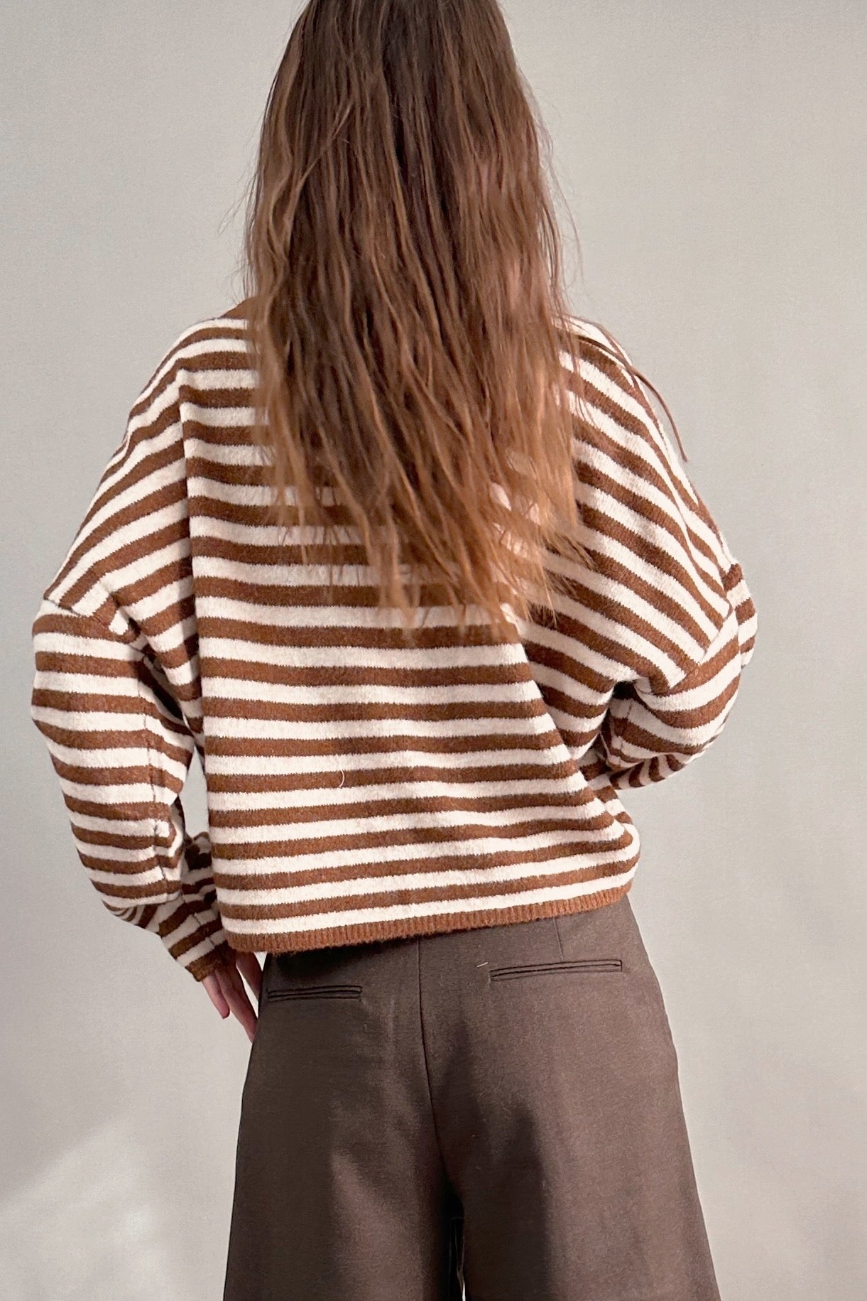 Back view of Hailey Button Down Cardigan in Ivory Brown Stripe styled with brown shorts, casual everyday look