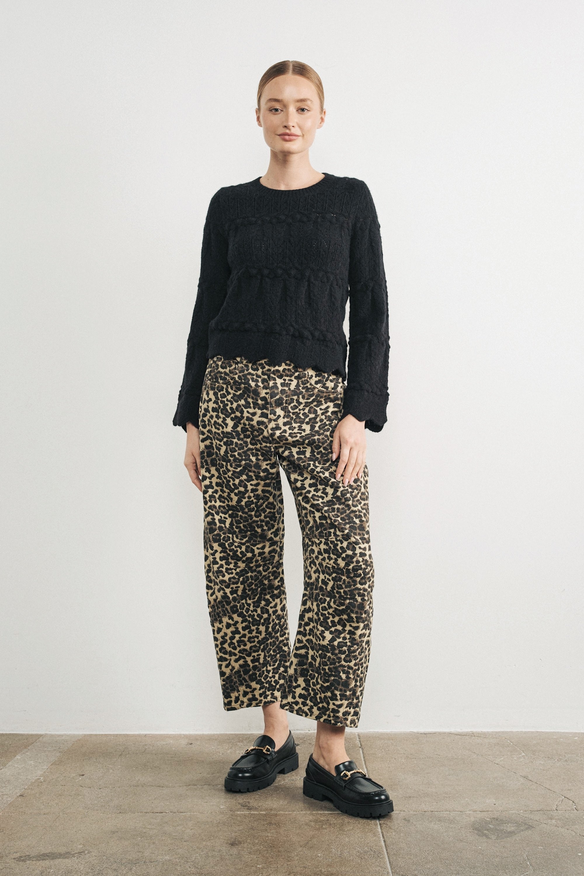 Woman wearing Good Luck Barrel Jeans in Leopard and black sweater - front view