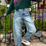 Outdoor image of woman is wearing  Good Luck Barrel Jeans in Washed Denim - front view