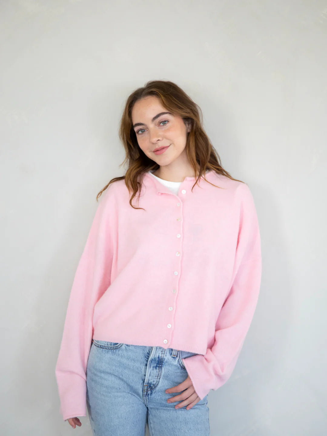 model is wearing Hailey button down cardigan (piper cardigan) in baby pink - front view