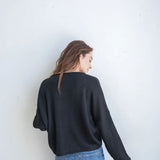 Black Hailey Button Down Cardigan front view, soft lightweight knit cardigan with button front and relaxed rolled edges - back view