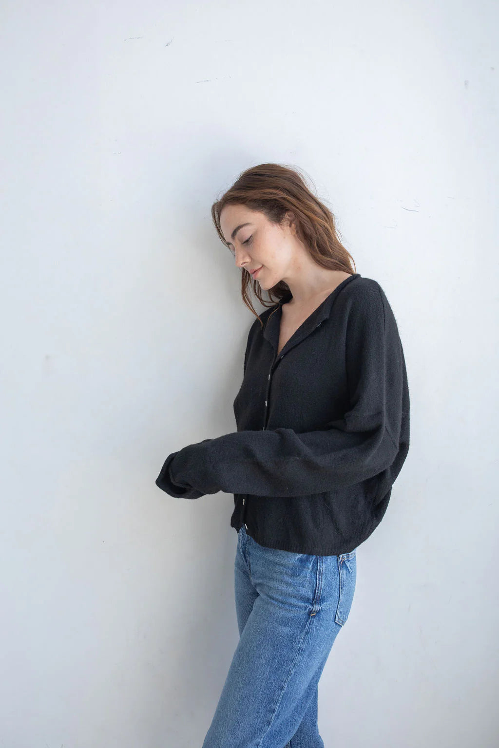Black Hailey Button Down Cardigan front view, soft lightweight knit cardigan with button front and relaxed rolled edges - side view