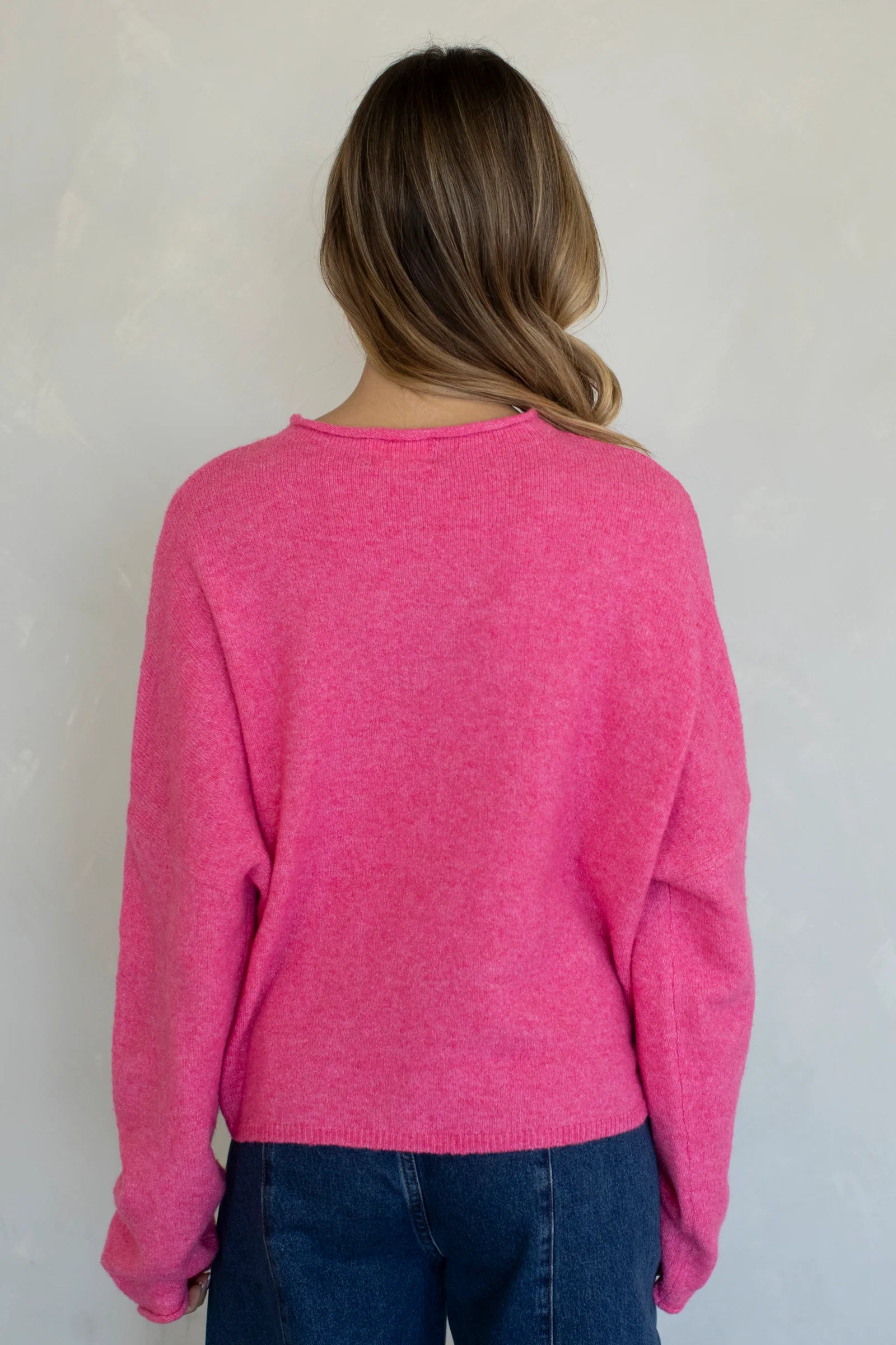 Model is wearing Hailey Button Down Cardigan in Bubblegum - back view