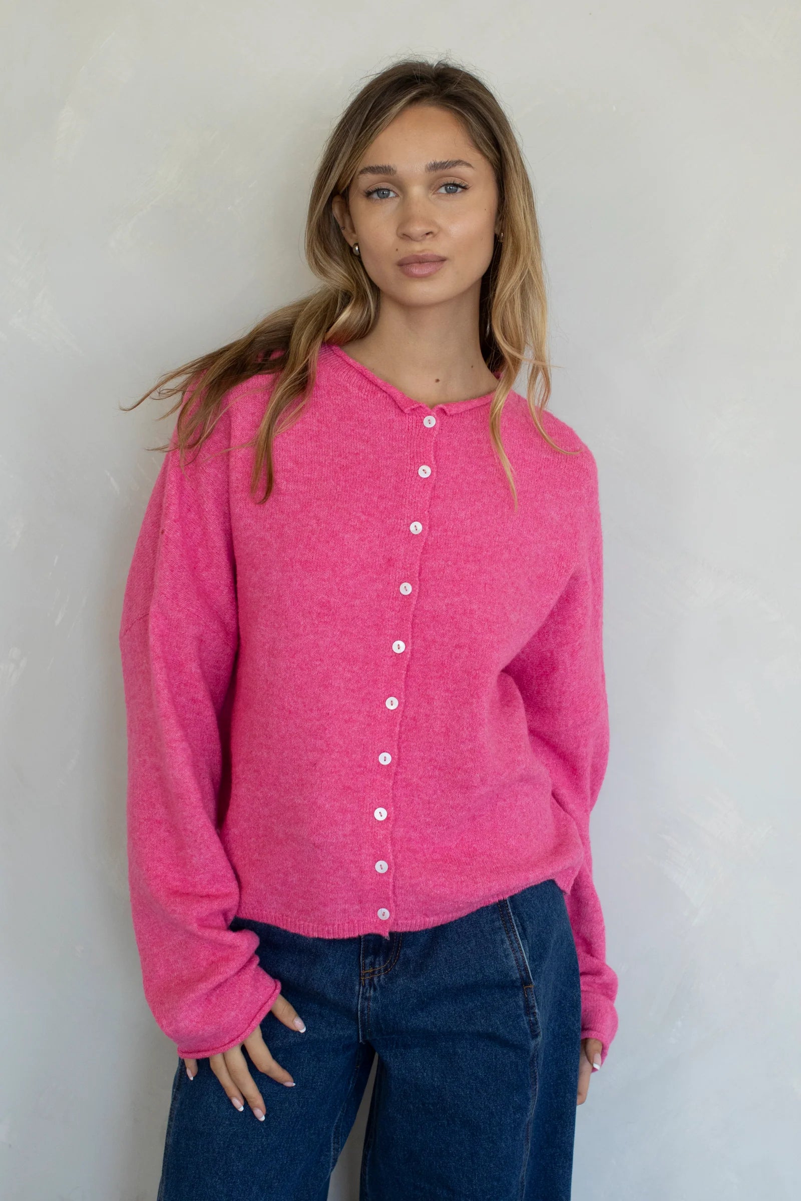 Model is wearing Hailey Button Down Cardigan in Bubblegum - front