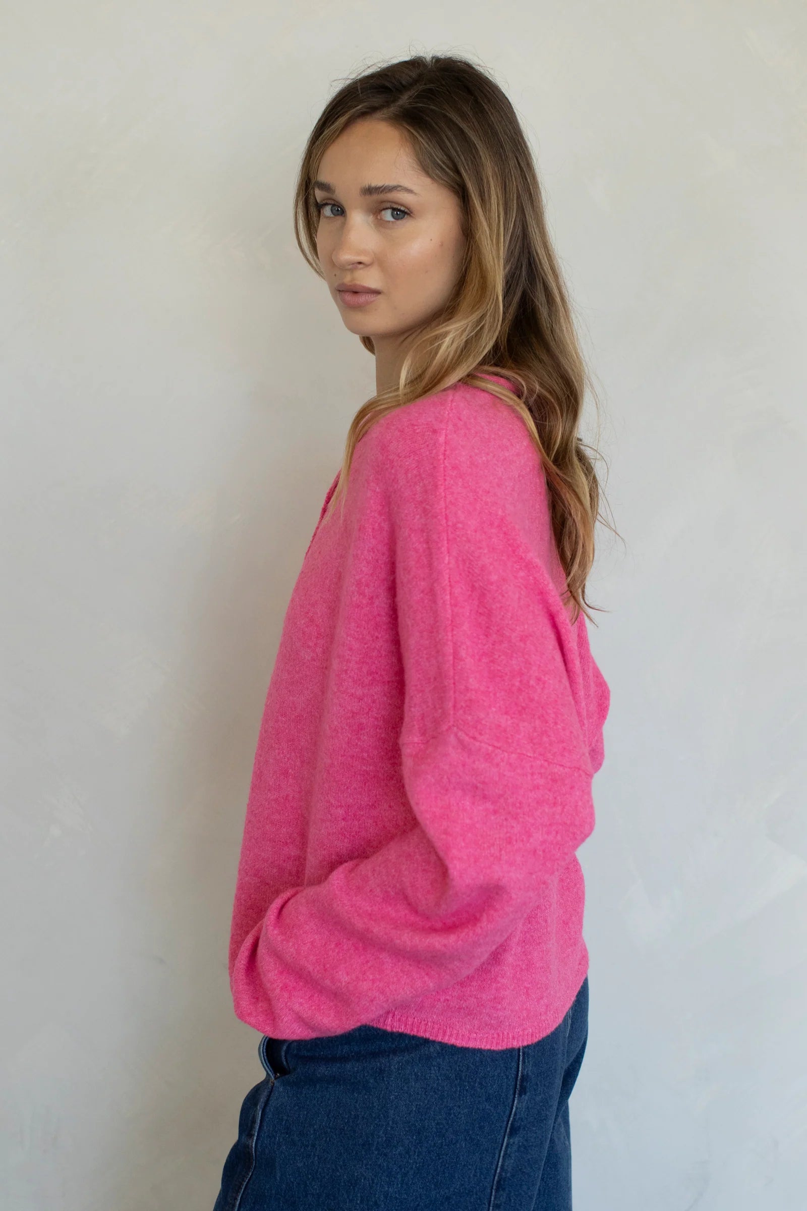 Model is wearing Hailey Button Down Cardigan in Bubblegum - side view