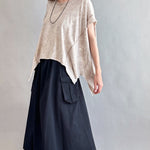 Woman is wearing Trinity Flowy Oversized Top in beige - side view