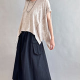 Woman is wearing Trinity Flowy Oversized Top in beige - side view