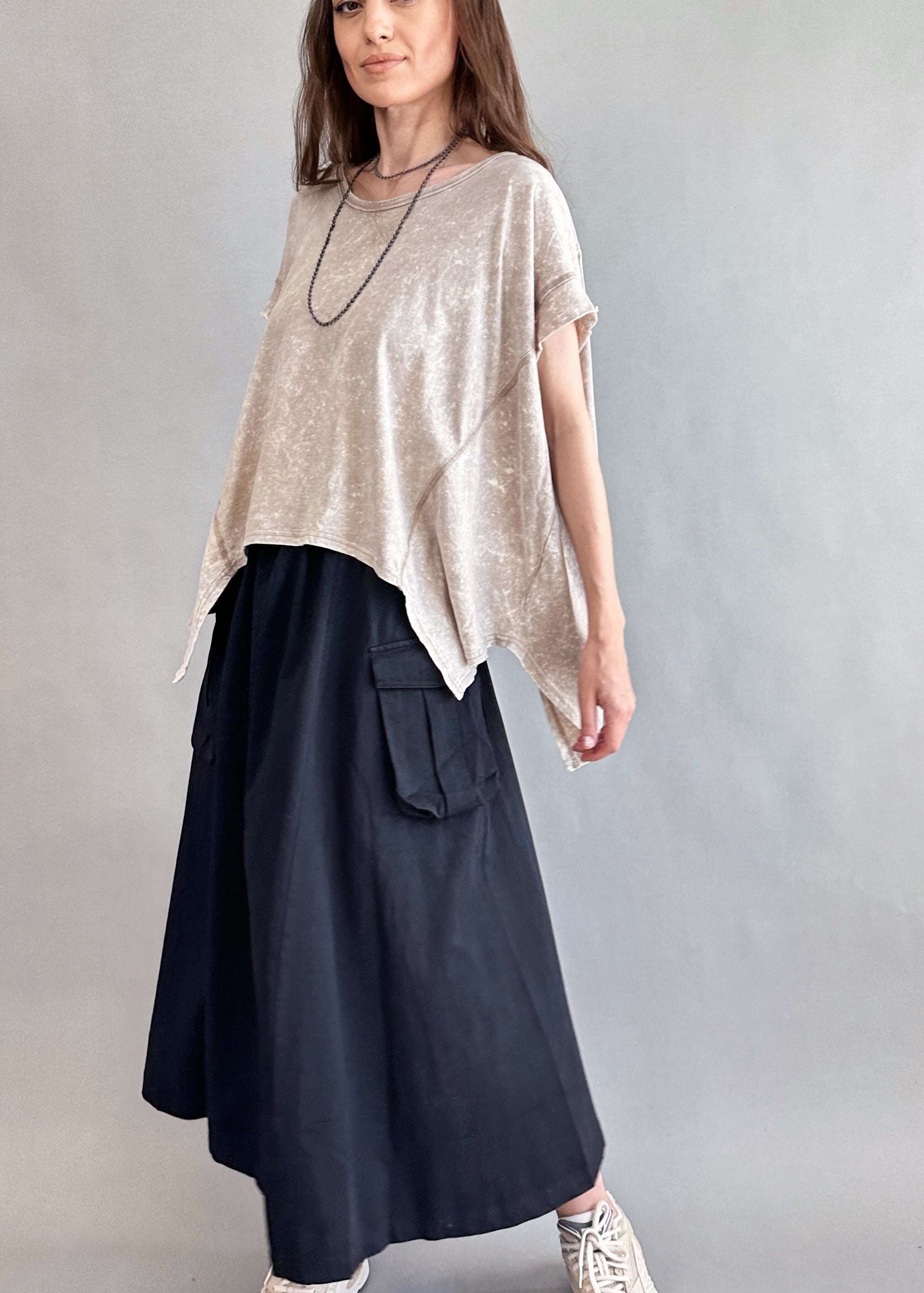 Woman is wearing Trinity Flowy Oversized Top in beige - side view