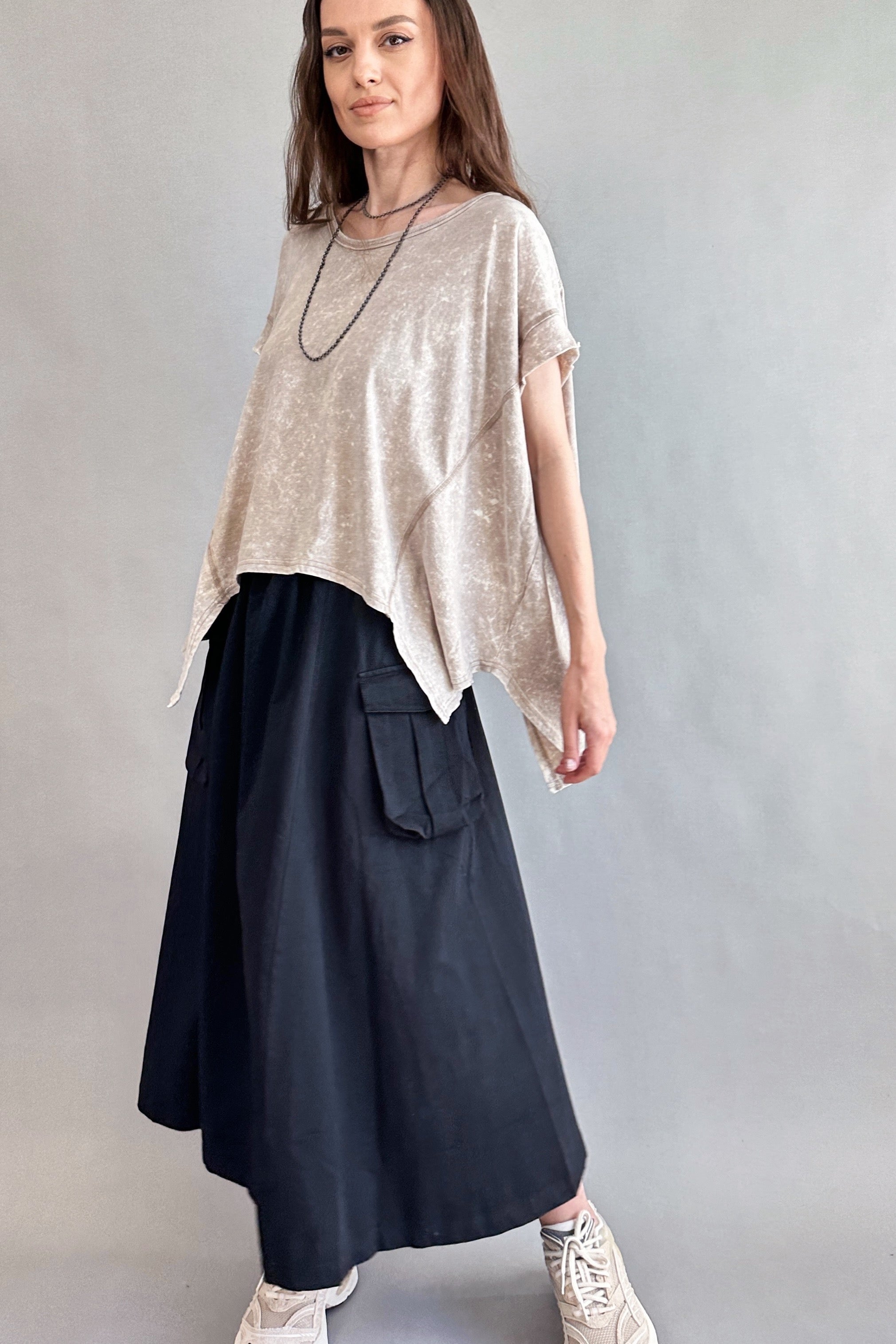 Woman is wearing Trinity Flowy Oversized Top in beige - side view