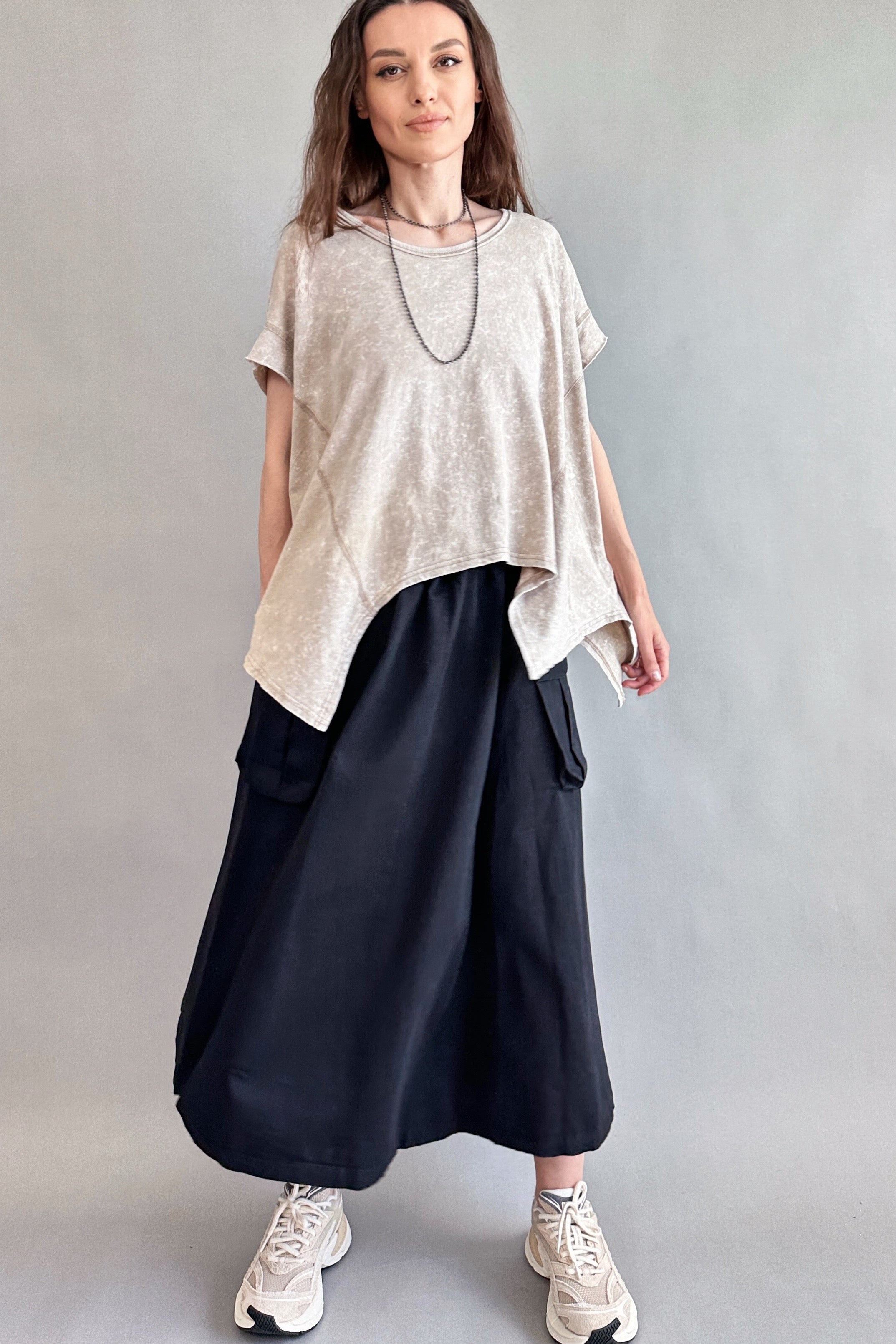 Woman is wearing Trinity Flowy Oversized Top in beige - front view