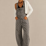 Aaron & Amber barrel-leg denim overalls in washed black with white polka dots, front view