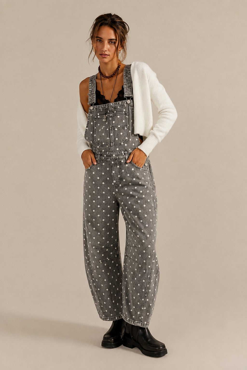 Aaron & Amber barrel-leg denim overalls in washed black with white polka dots, front view
