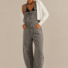 Aaron & Amber barrel-leg denim overalls in washed black with white polka dots, front view
