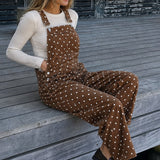 Woman sitting in Aaron & Amber brown polka dot barrel overalls styled for a casual everyday look