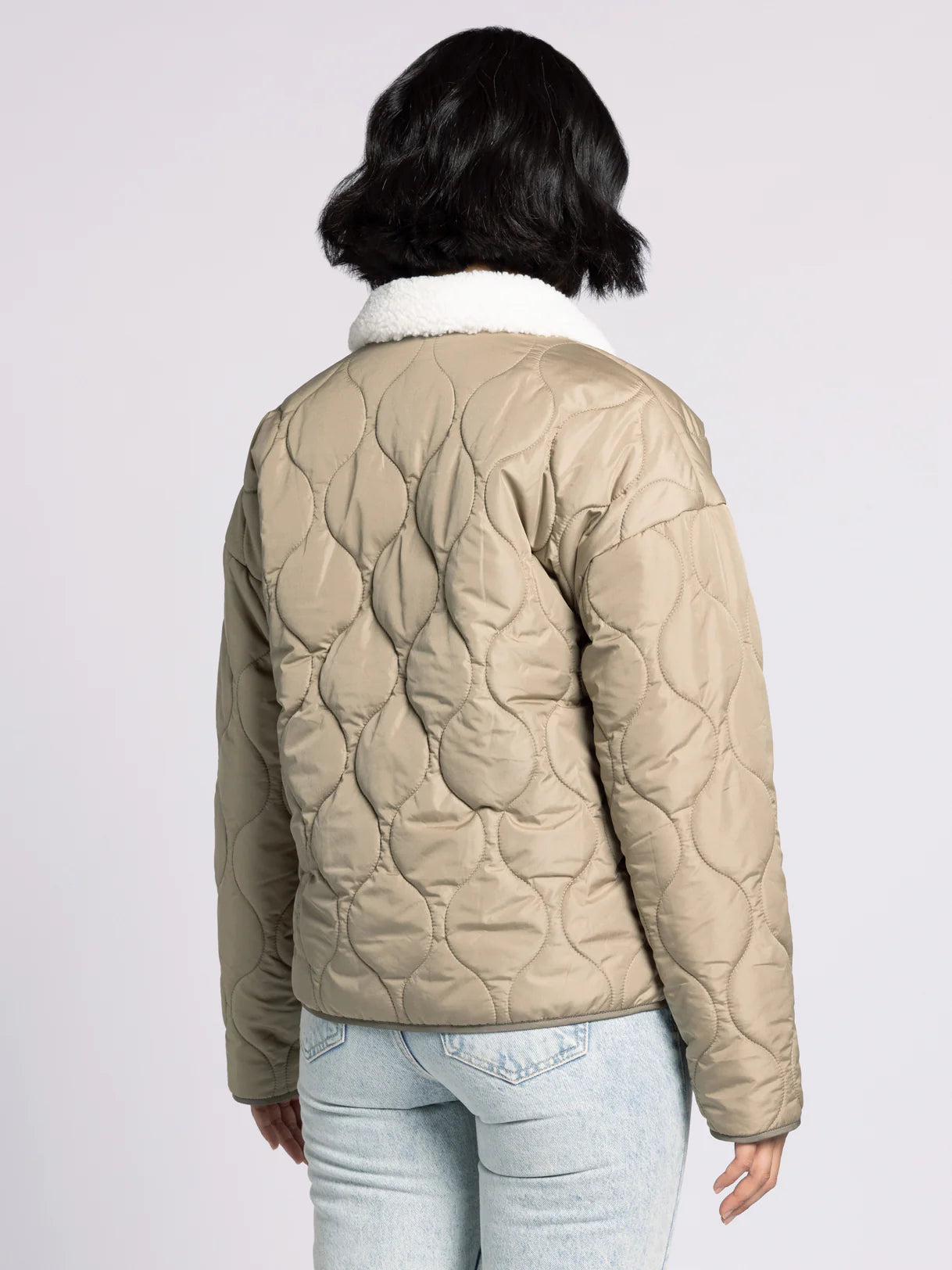 Back of Aura Sherpa Collar Puffer Coat in olive — women’s quilted coat with longline design.