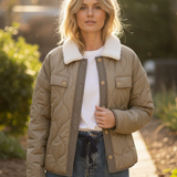 Woman wearing the Aura Sherpa Collar Quilted Puffer Coat in olive — soft quilted outerwear with cozy sherpa collar- lifestyle 