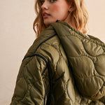 Hood view of the olive hooded quilted puffer jacket styled with jeans for everyday layering