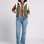 Ava Reversible Sherpa Quilted Vest by Dani West styled with jeans and sweater — cozy women’s layering outfit.