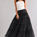 Black cotton tiered maxi skirt with a flowy A-line fit and lightweight sheer texture