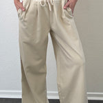The Brooklin side-stripe pull-on wide-leg pants in beige, front view with elastic waist and tie detail