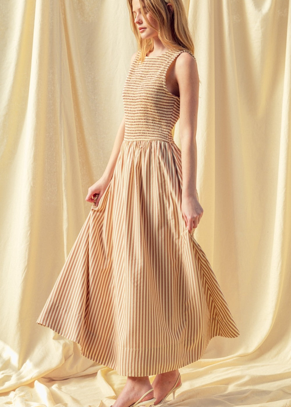Full length brown striped smocked maxi dress with flowing skirt