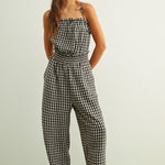 Black and white gingham smocked jumpsuit with barrel-leg fit and lightweight cotton fabric