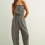 Black and white gingham smocked jumpsuit with barrel-leg fit and lightweight cotton fabric