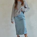 Full body view of Carly fuzzy knit pullover sweater styled with midi skirt