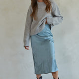 Full body view of Carly fuzzy knit pullover sweater styled with midi skirt