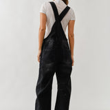 Back view of chill denim overall in black wash with adjustable straps