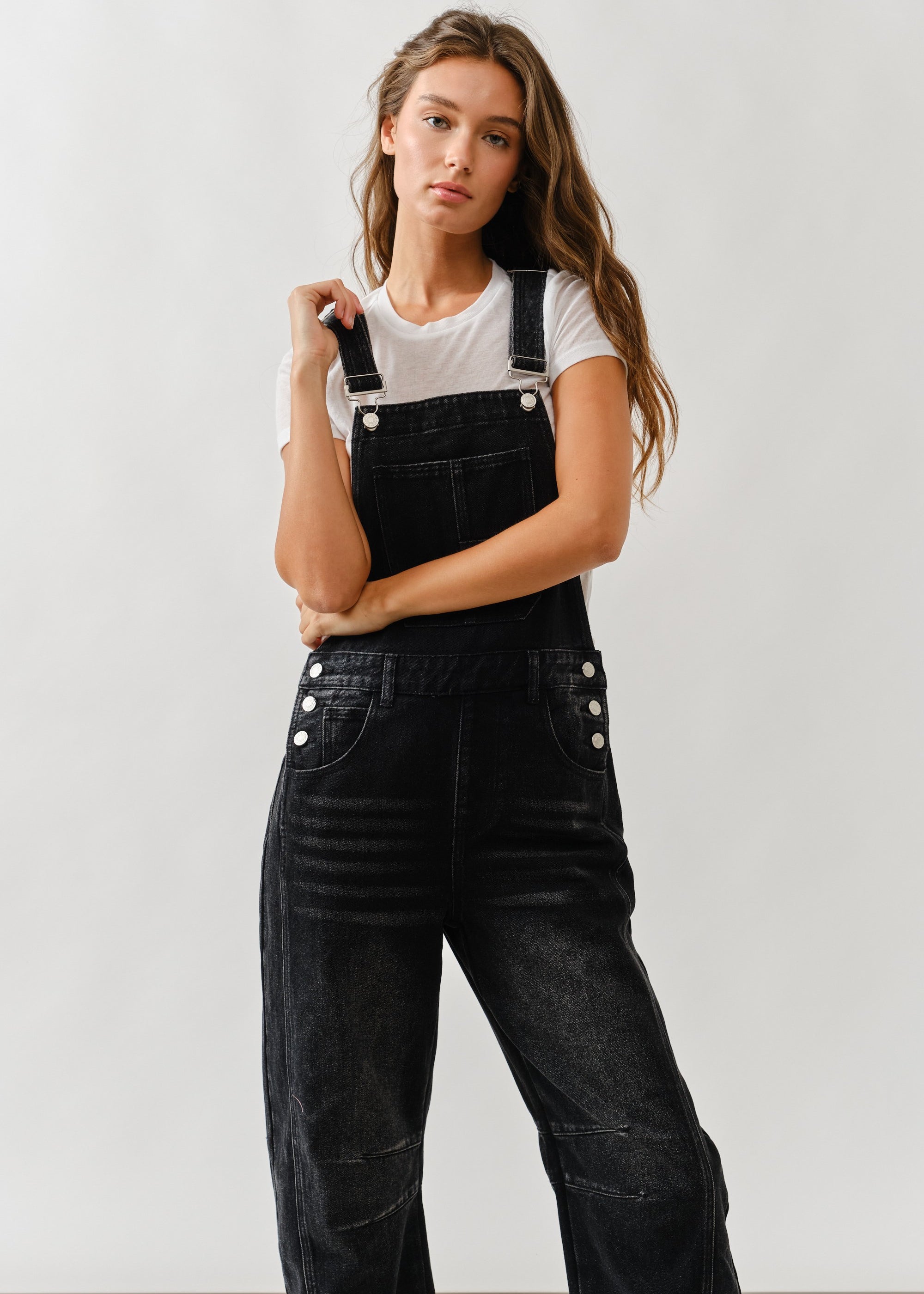 Close-up of front bib and pockets on chill denim overall in black wash