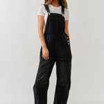 Full body view of chill denim overall in black wash styled casually