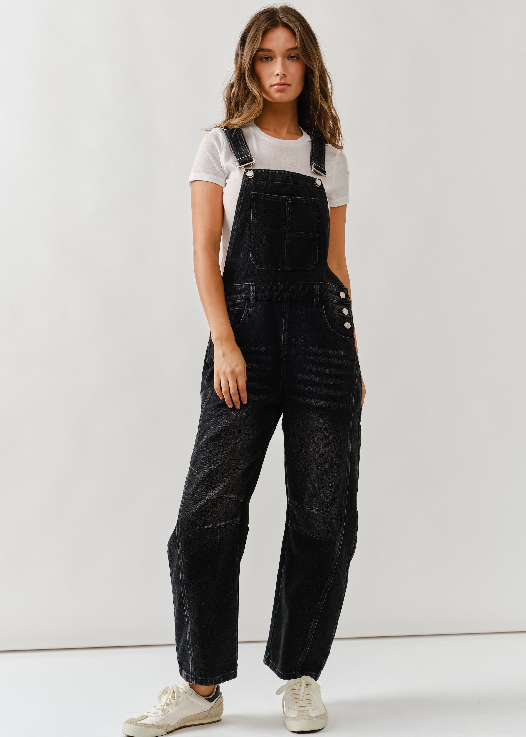 Full body view of chill denim overall in black wash styled casually