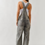 Back view of chill denim overall in grey wash with adjustable straps