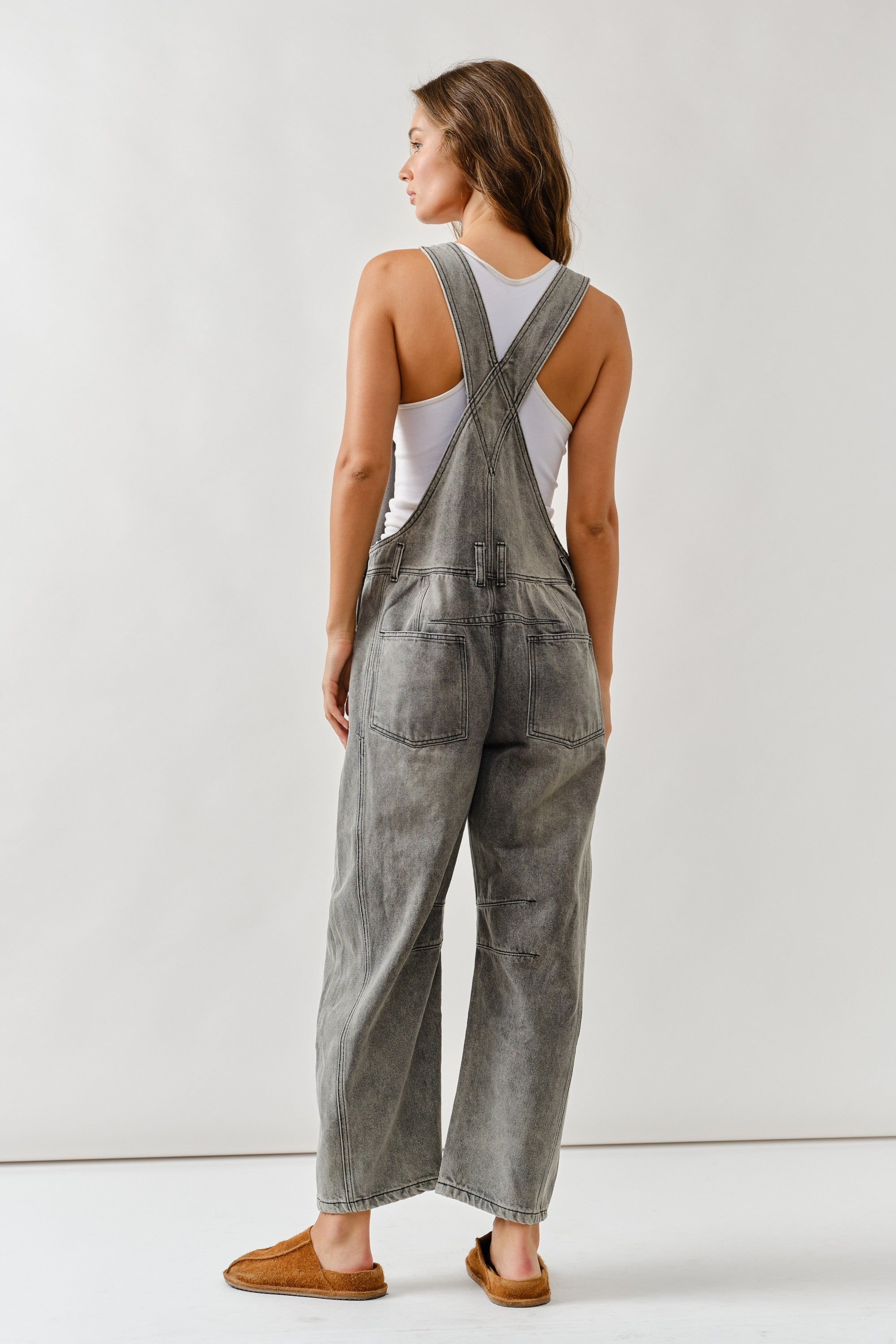 Back view of chill denim overall in grey wash with adjustable straps