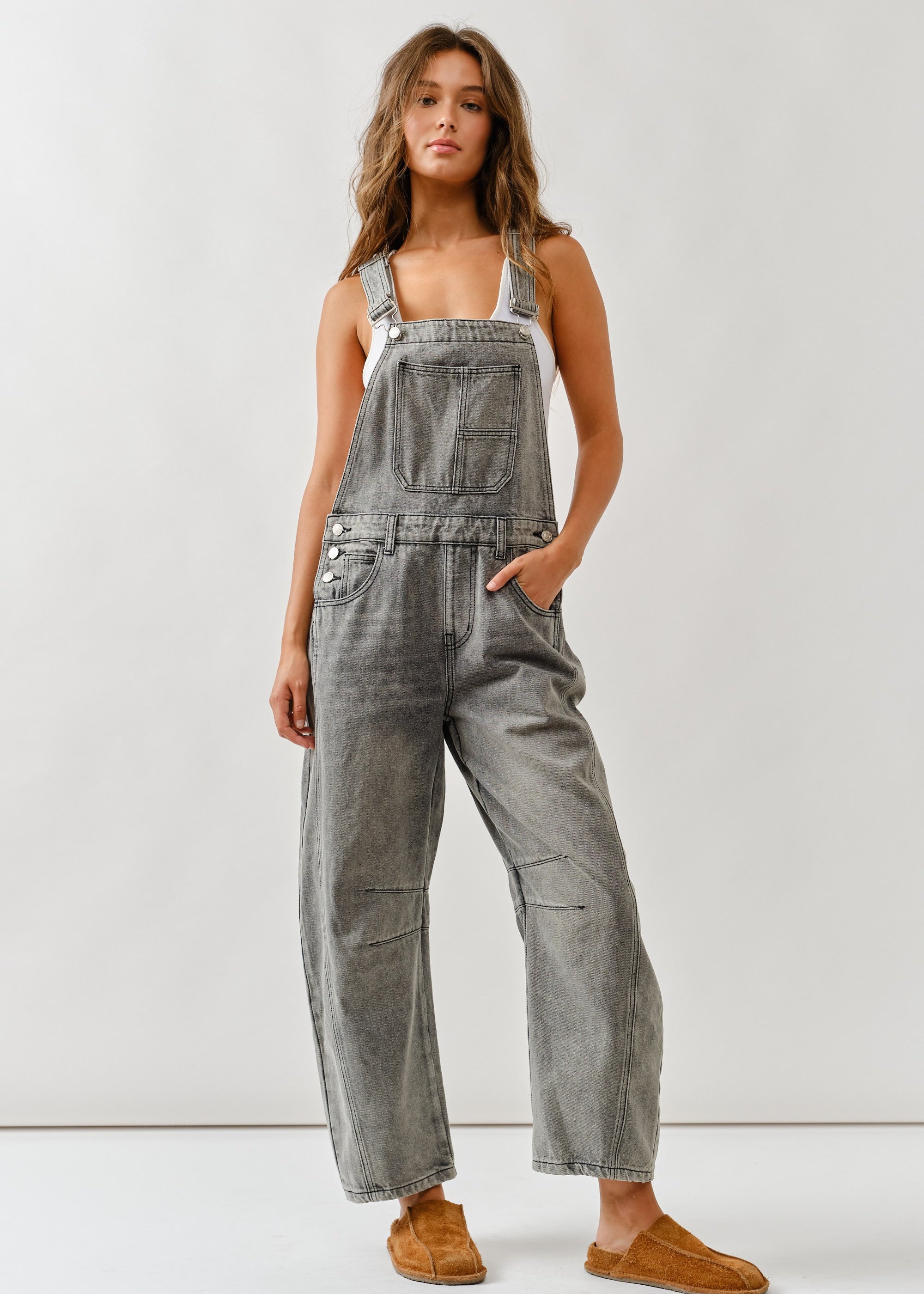 Full body front view of chill denim overall in grey wash with barrel-fit legs