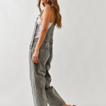 Side view of chill denim overall in grey wash showing relaxed silhouette