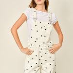 Front close-up of   Chill Denim Overall (good luck overall) in cream denim with black polka dots