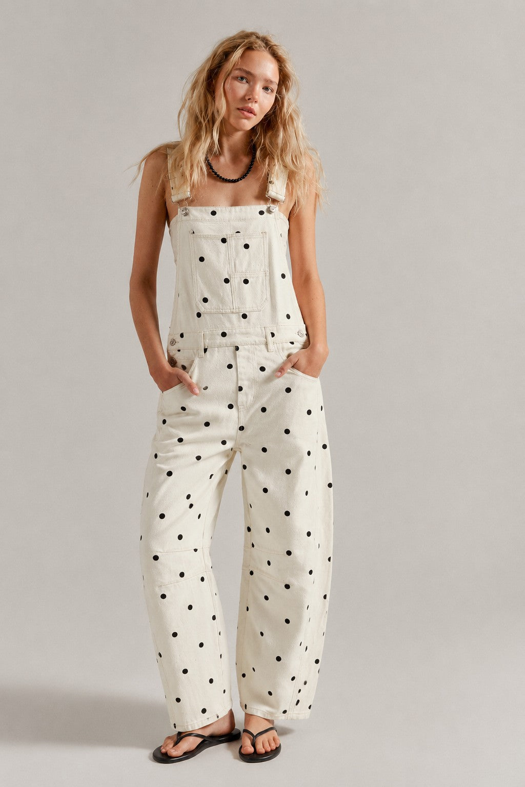 Woman wearing  Chill Denim Overall (Good Luck Overall) in cream polka dot 