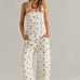 Woman wearing  Aaron & Amber Barrel-Leg Denim Overalls in Cream Polka Dot - front view