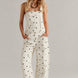 Woman wearing  Chill Denim Overall (Good Luck Overall) in cream polka dot 