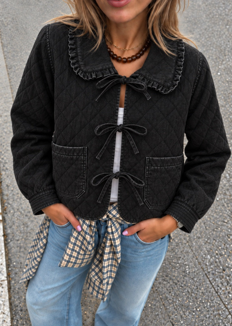 Woman wearing Chloe black tie-front quilted denim jacket with lace-trimmed collar